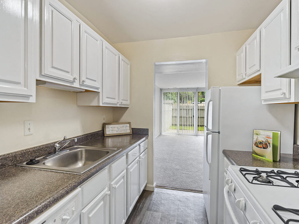 A bright kitchen with white cabinets at the University Heights apartments in Providence, Rhode Island.